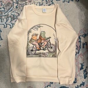 Frogs riding a bike crew neck